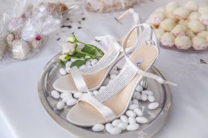 scarpe da sposa su vassoio pieno di confetti
